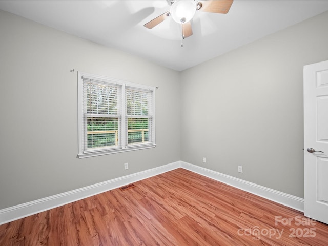 unfurnished room with hardwood / wood-style flooring and ceiling fan