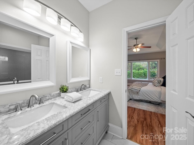 bathroom featuring tile patterned flooring, vanity, and ceiling fan