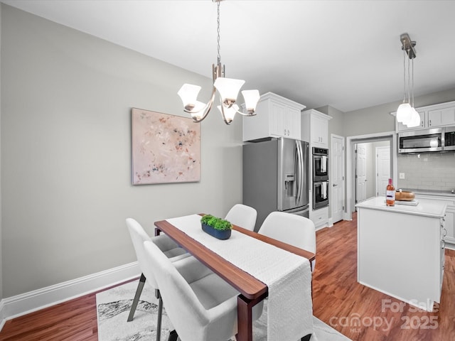 dining room with a notable chandelier and hardwood / wood-style flooring