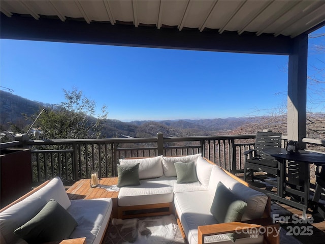 deck featuring an outdoor living space and a mountain view