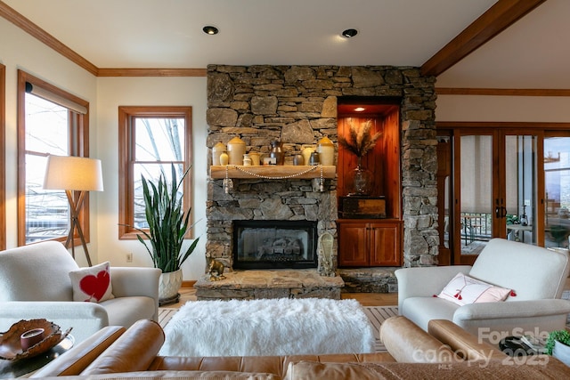 living room with crown molding, hardwood / wood-style floors, a fireplace, and french doors