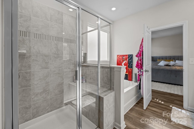 bathroom with wood-type flooring and separate shower and tub