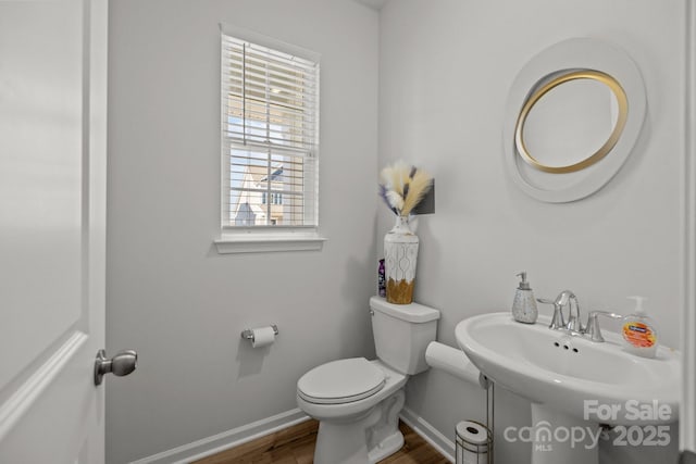 bathroom featuring sink, hardwood / wood-style flooring, and toilet