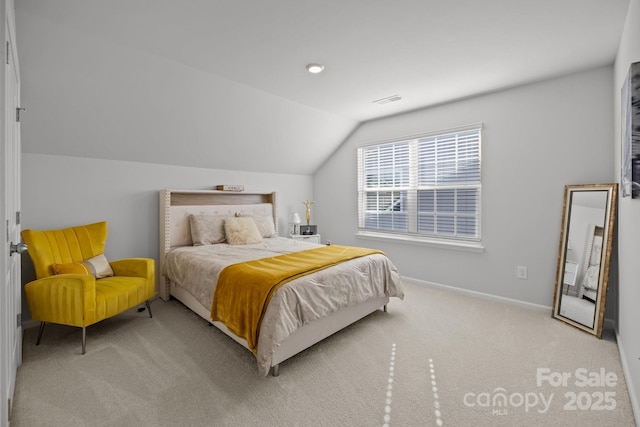 carpeted bedroom with vaulted ceiling