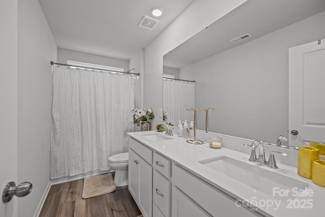 bathroom with a shower with shower curtain, vanity, toilet, and hardwood / wood-style floors