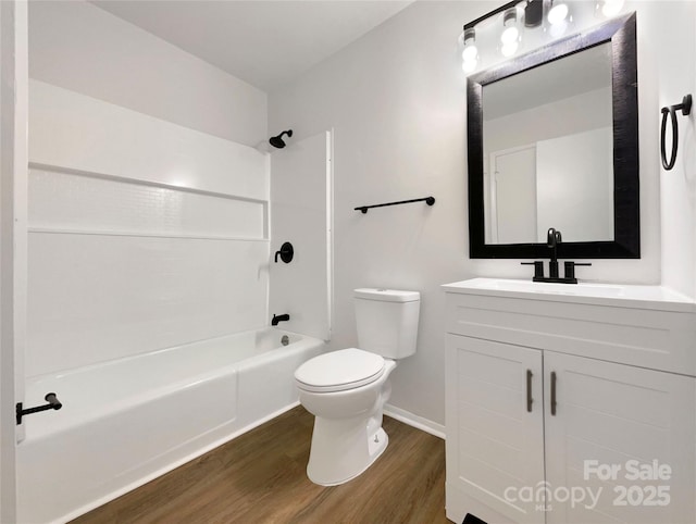 full bathroom with wood-type flooring, toilet, bathing tub / shower combination, and vanity