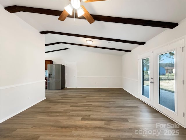 empty room with ceiling fan, vaulted ceiling with beams, dark hardwood / wood-style flooring, and french doors