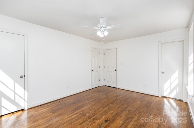 unfurnished room with ceiling fan, baseboards, and wood finished floors