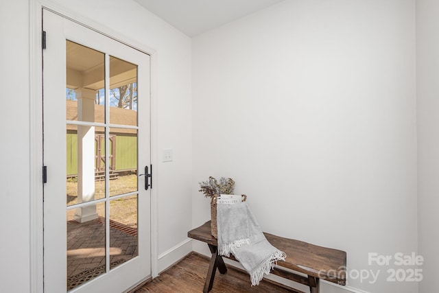 doorway featuring wood finished floors and baseboards