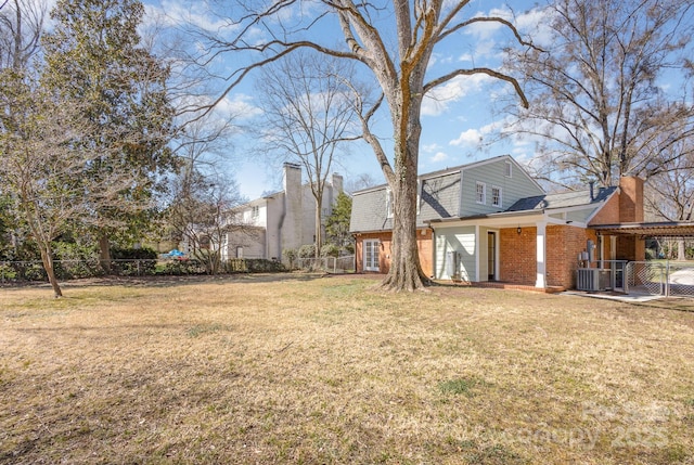 view of yard featuring cooling unit and fence