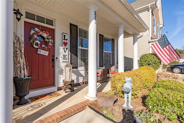 view of exterior entry with covered porch