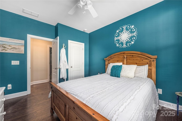 bedroom with dark hardwood / wood-style floors and ceiling fan