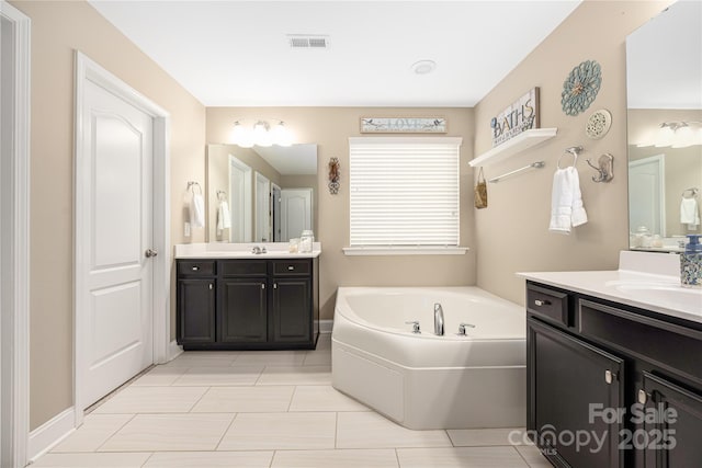 bathroom with vanity and a tub to relax in