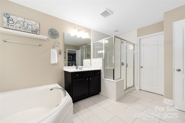 bathroom featuring vanity and separate shower and tub