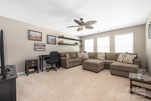 carpeted living room featuring ceiling fan