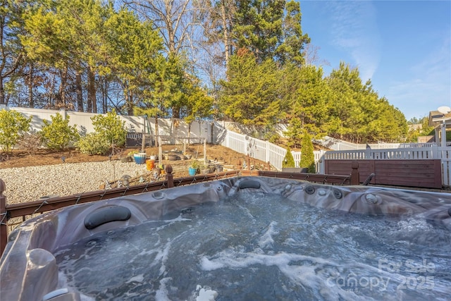 view of swimming pool with a hot tub