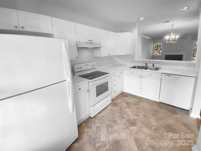 kitchen featuring sink, white cabinets, and white appliances