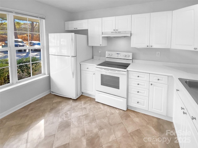 kitchen with plenty of natural light, white cabinets, and white appliances