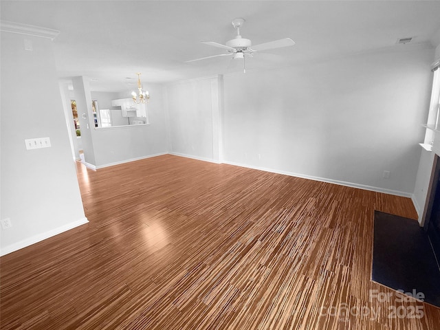 empty room featuring hardwood / wood-style flooring and ceiling fan with notable chandelier