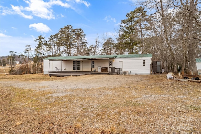 back of property featuring a wooden deck