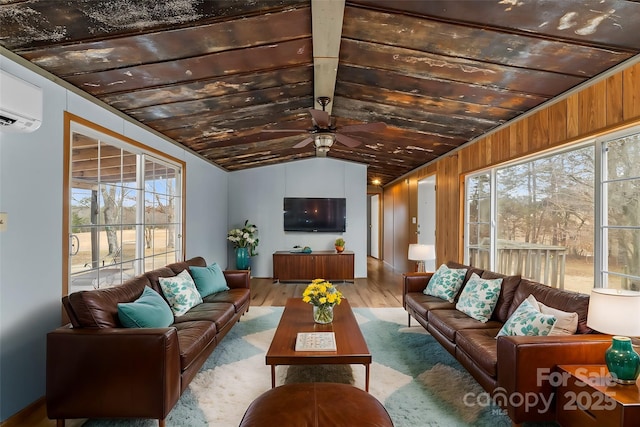 sunroom / solarium with ceiling fan, plenty of natural light, a wall mounted AC, and vaulted ceiling