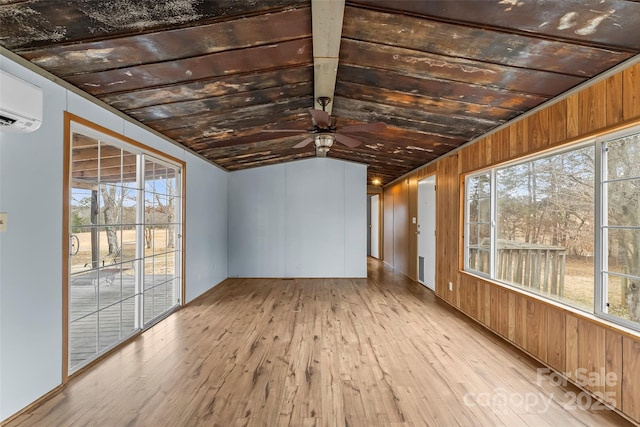 unfurnished sunroom featuring ceiling fan, lofted ceiling, and a healthy amount of sunlight