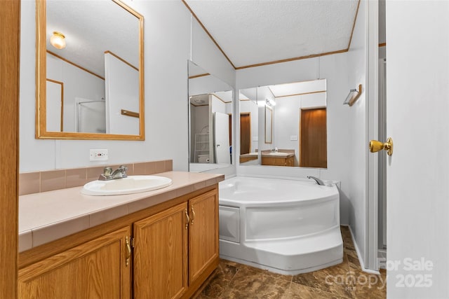 bathroom featuring a bathtub, ornamental molding, and a textured ceiling