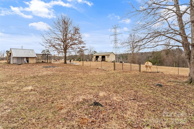 view of yard with an outdoor structure and a rural view