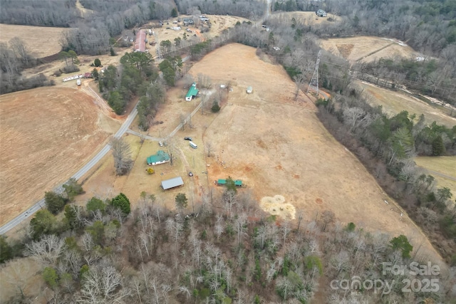 birds eye view of property featuring a rural view