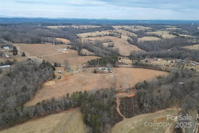 birds eye view of property featuring a rural view