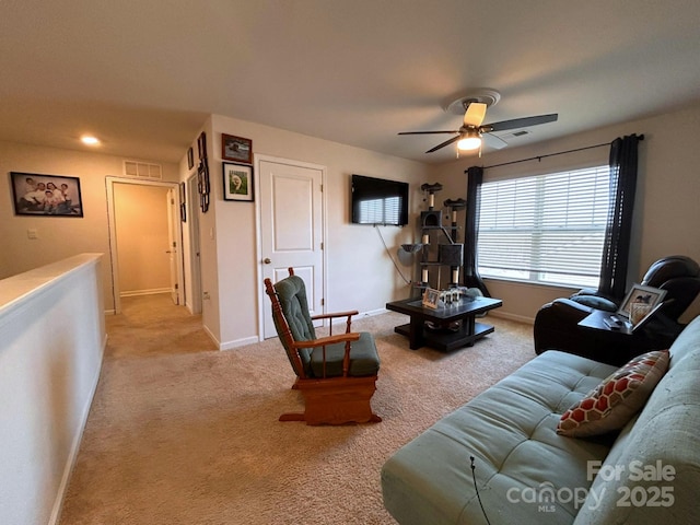 carpeted living room featuring ceiling fan