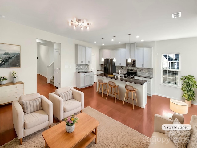 living room featuring dark hardwood / wood-style floors and sink