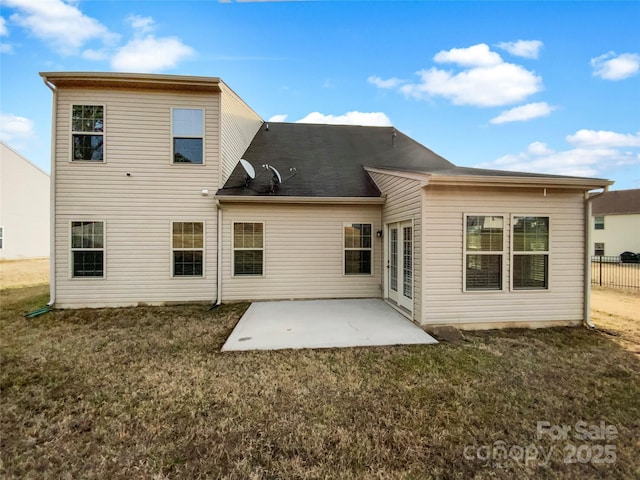 back of property featuring a yard and a patio area