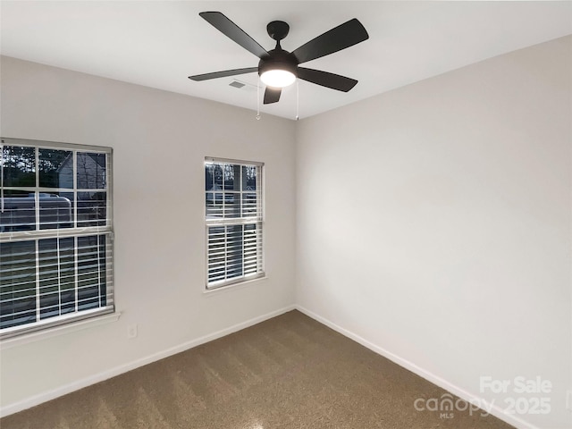 empty room featuring ceiling fan and carpet flooring