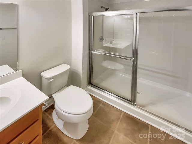 bathroom featuring vanity, toilet, and an enclosed shower