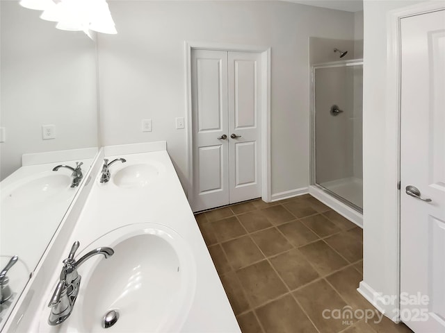 bathroom featuring tile patterned floors, an enclosed shower, and vanity