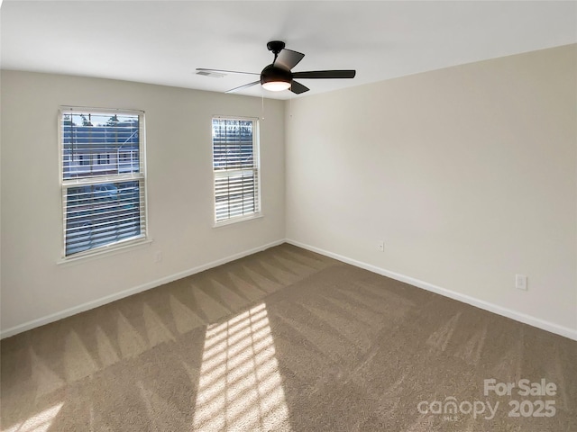 carpeted spare room with ceiling fan