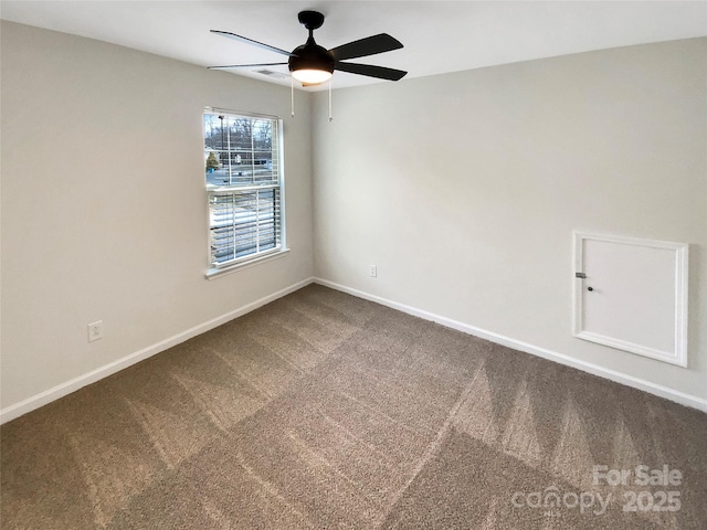 spare room featuring ceiling fan and carpet