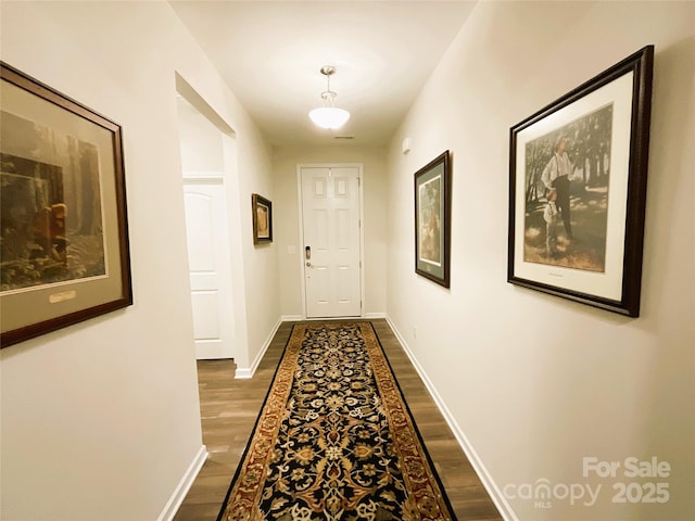 hallway featuring dark hardwood / wood-style floors