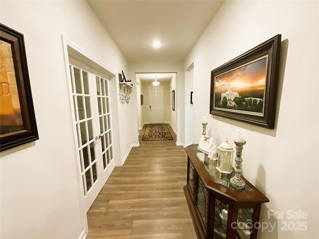 hallway with french doors and hardwood / wood-style flooring