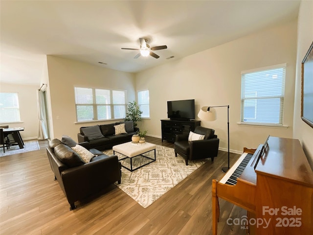 living room with hardwood / wood-style flooring, a healthy amount of sunlight, and ceiling fan