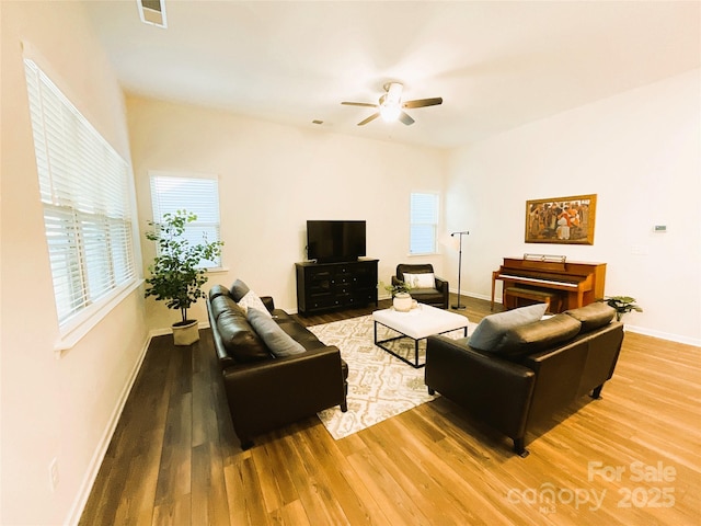 living room featuring ceiling fan and hardwood / wood-style floors