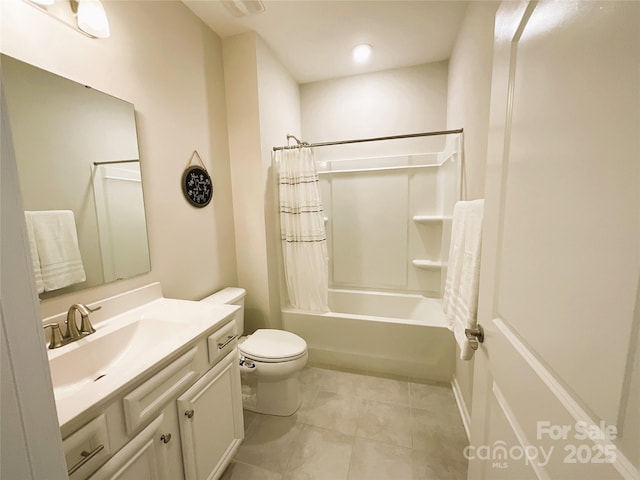 full bathroom with tile patterned flooring, vanity, toilet, and shower / bath combo with shower curtain