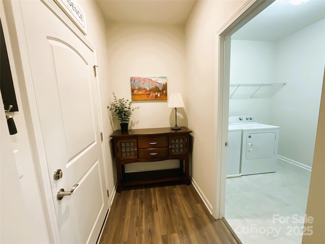 interior space with dark hardwood / wood-style floors and washing machine and clothes dryer