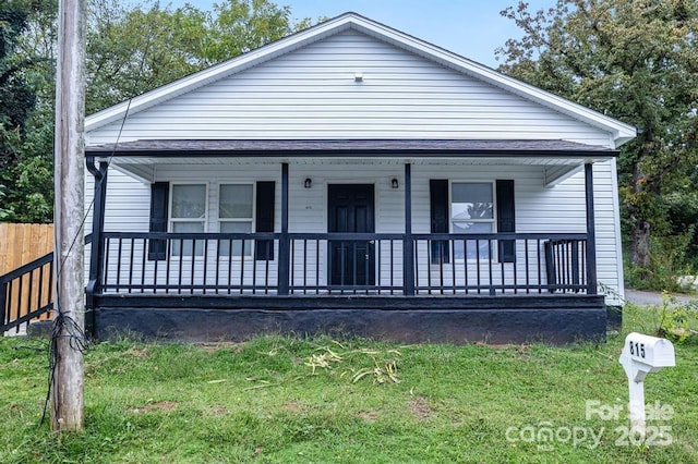 bungalow-style home featuring a front yard and covered porch