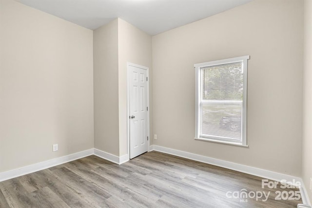 spare room featuring light hardwood / wood-style floors