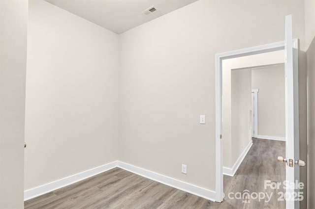 unfurnished room featuring hardwood / wood-style flooring