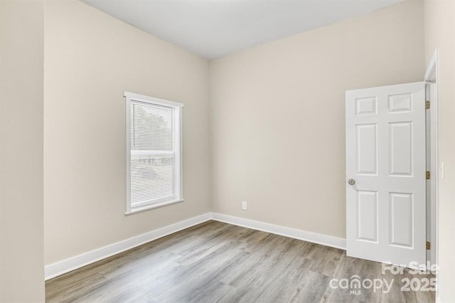 spare room with light hardwood / wood-style flooring