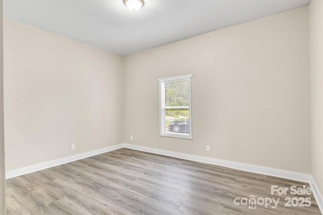 spare room with wood-type flooring