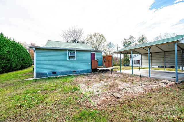 exterior space featuring a lawn and a carport